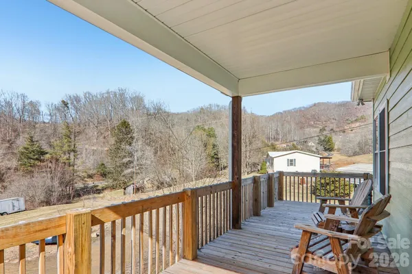 a view of a balcony with furniture and wooden fence