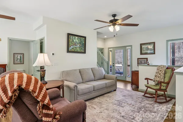 a living room with furniture and a chandelier