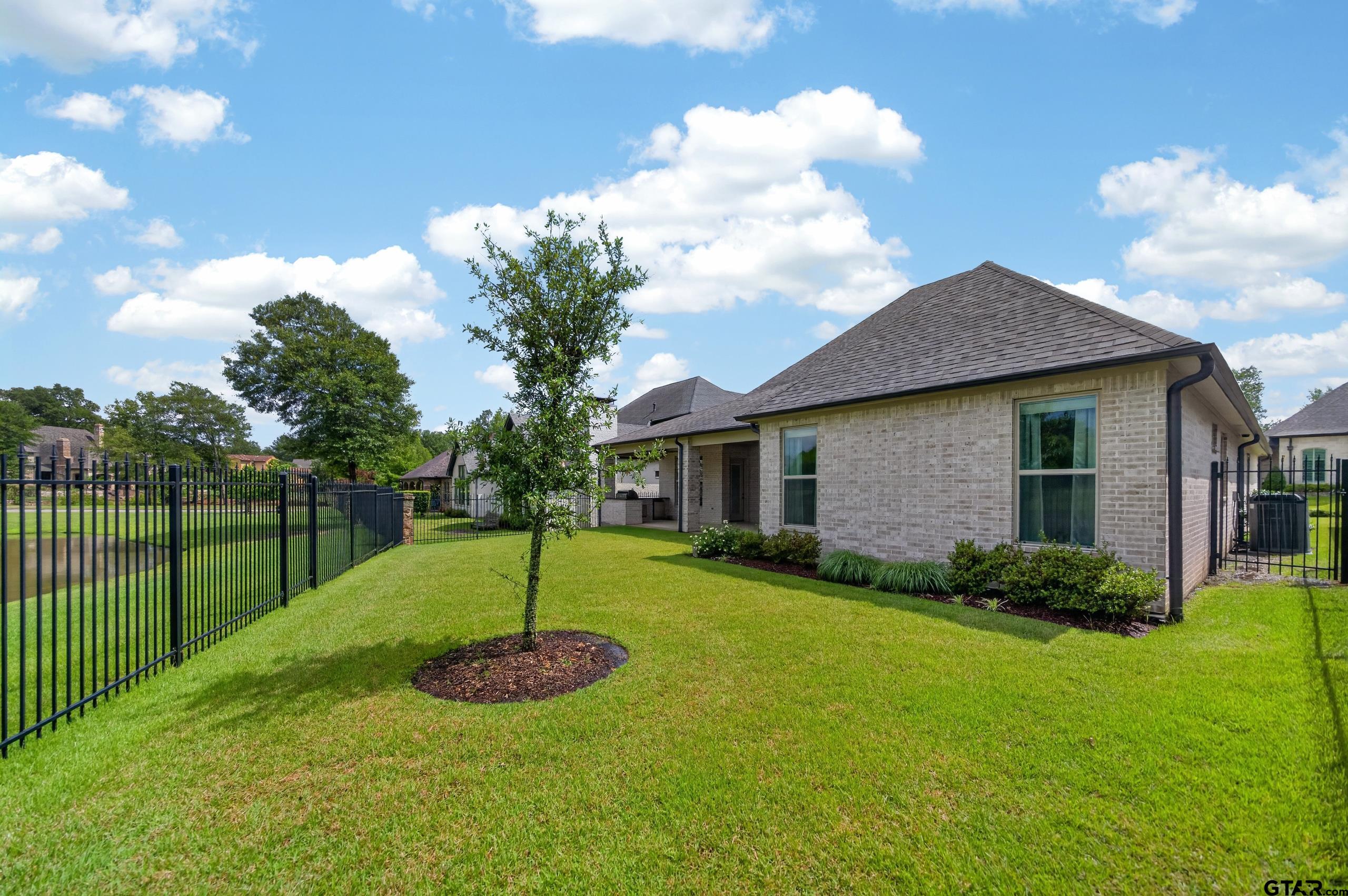 7517 Cross Gate Way Tyler, TX 75703 - Photo 26 of 47 a view of a house with a yard and a garden