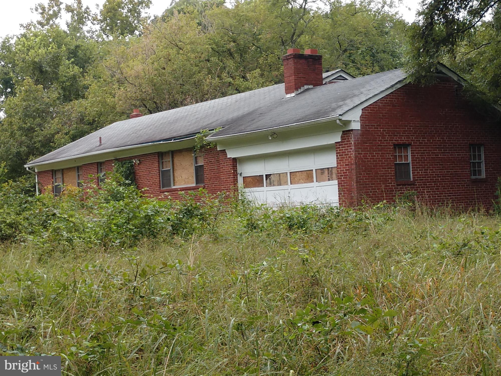 11901 Old Fort Road Fort Washington, MD 20744 - Photo 2 of 2 a view of a house with brick walls and a yard