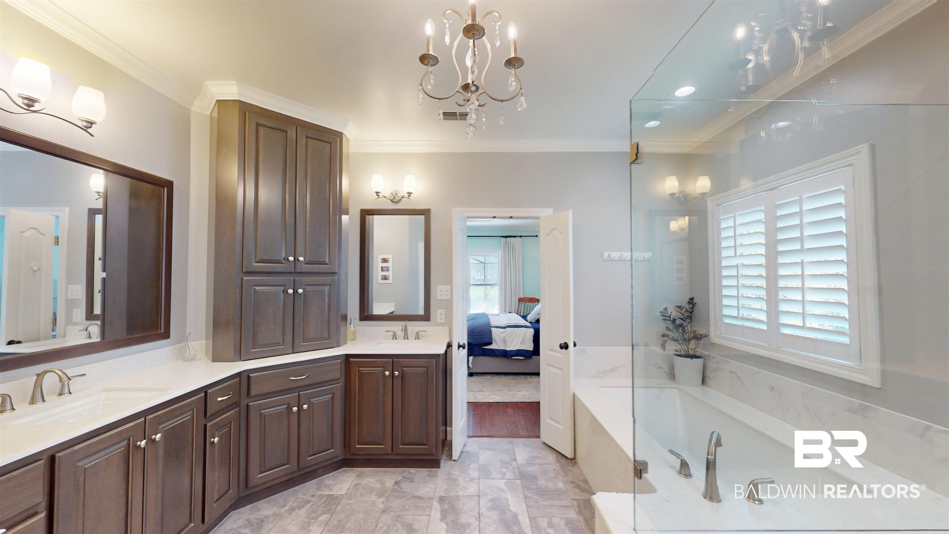 8775 Dawes Lake Road North Mobile, AL 36619 - Photo 28 of 59 Bathroom featuring crown molding, a bath, double vanity, connected bathroom, and a chandelier