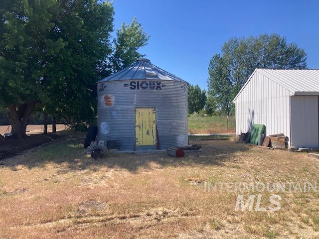 1095 County Road 70 Weiser, ID 83672 - Photo 36 of 44 Corrugated metal grain bin with a yellow wooden door
