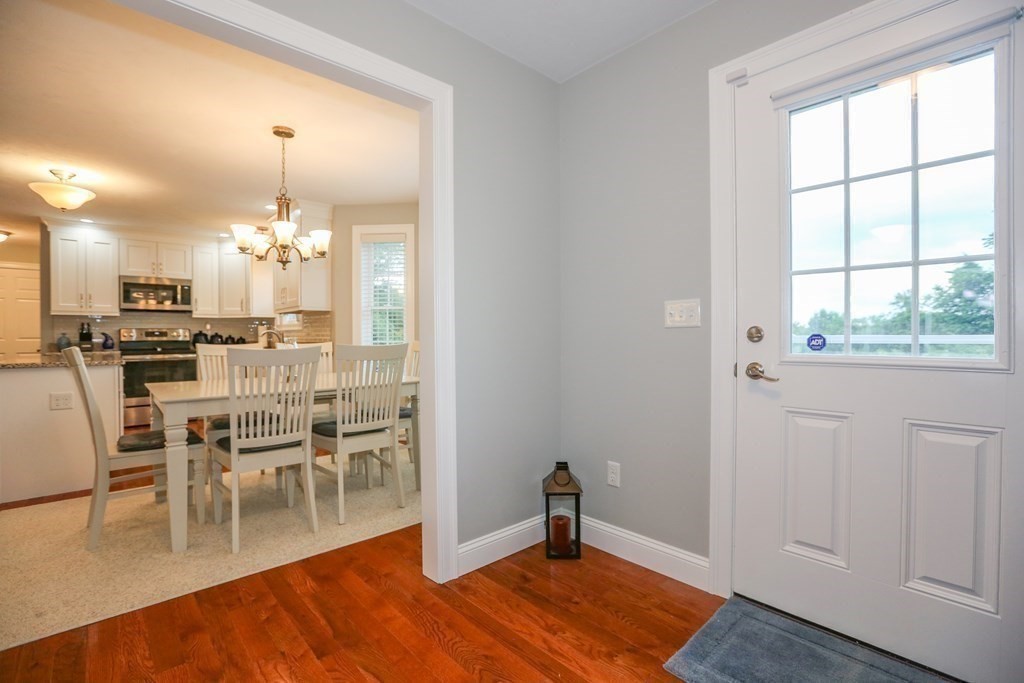 3 Jade Hill Road Auburn, MA 01501 - Photo 11 of 27 a view of a dining room with furniture a chandelier and wooden floor