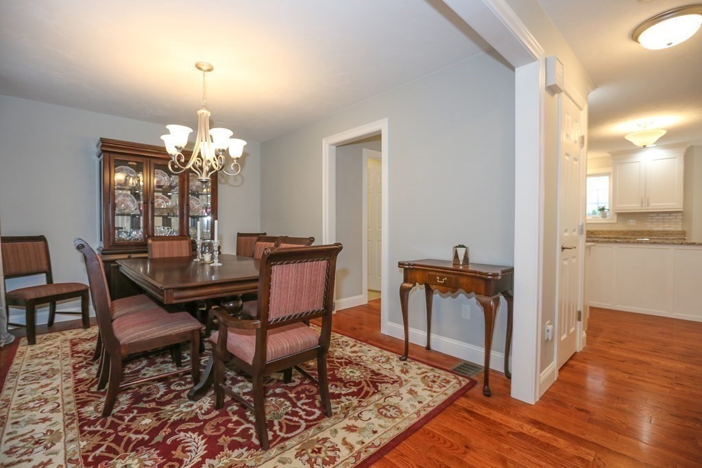 3 Jade Hill Road Auburn, MA 01501 - Photo 4 of 27 a dining room with furniture a chandelier and wooden floor