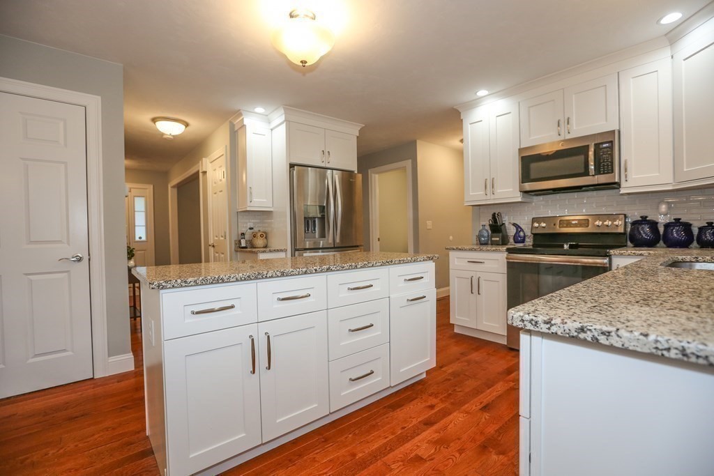 3 Jade Hill Road Auburn, MA 01501 - Photo 7 of 27 a large kitchen with stainless steel appliances granite countertop a lot of counter space and wooden floor