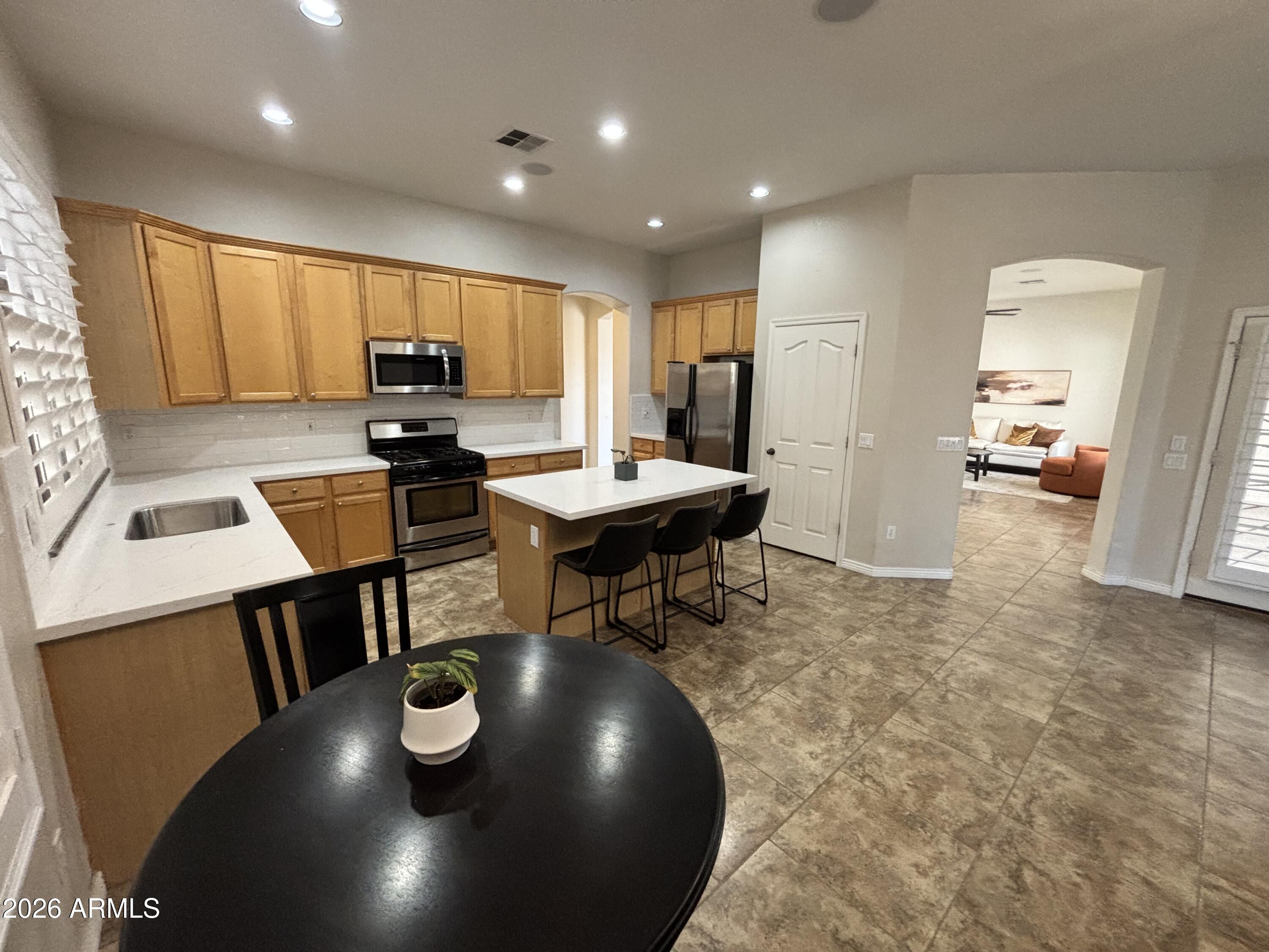 434 East Sheffield Avenue Gilbert, AZ 85296 - Photo 52 of 52 a kitchen with a table and chairs in it