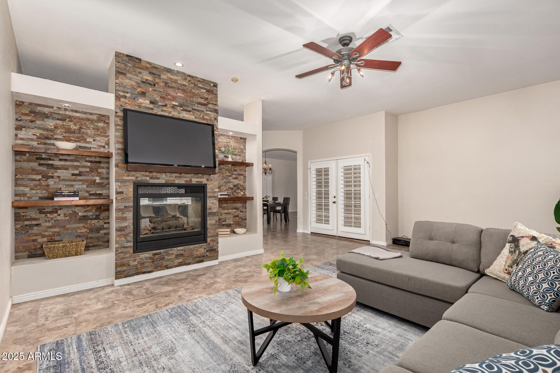 434 East Sheffield Avenue Gilbert, AZ 85296 - Photo 6 of 52 a living room with furniture a flat screen tv and a fireplace
