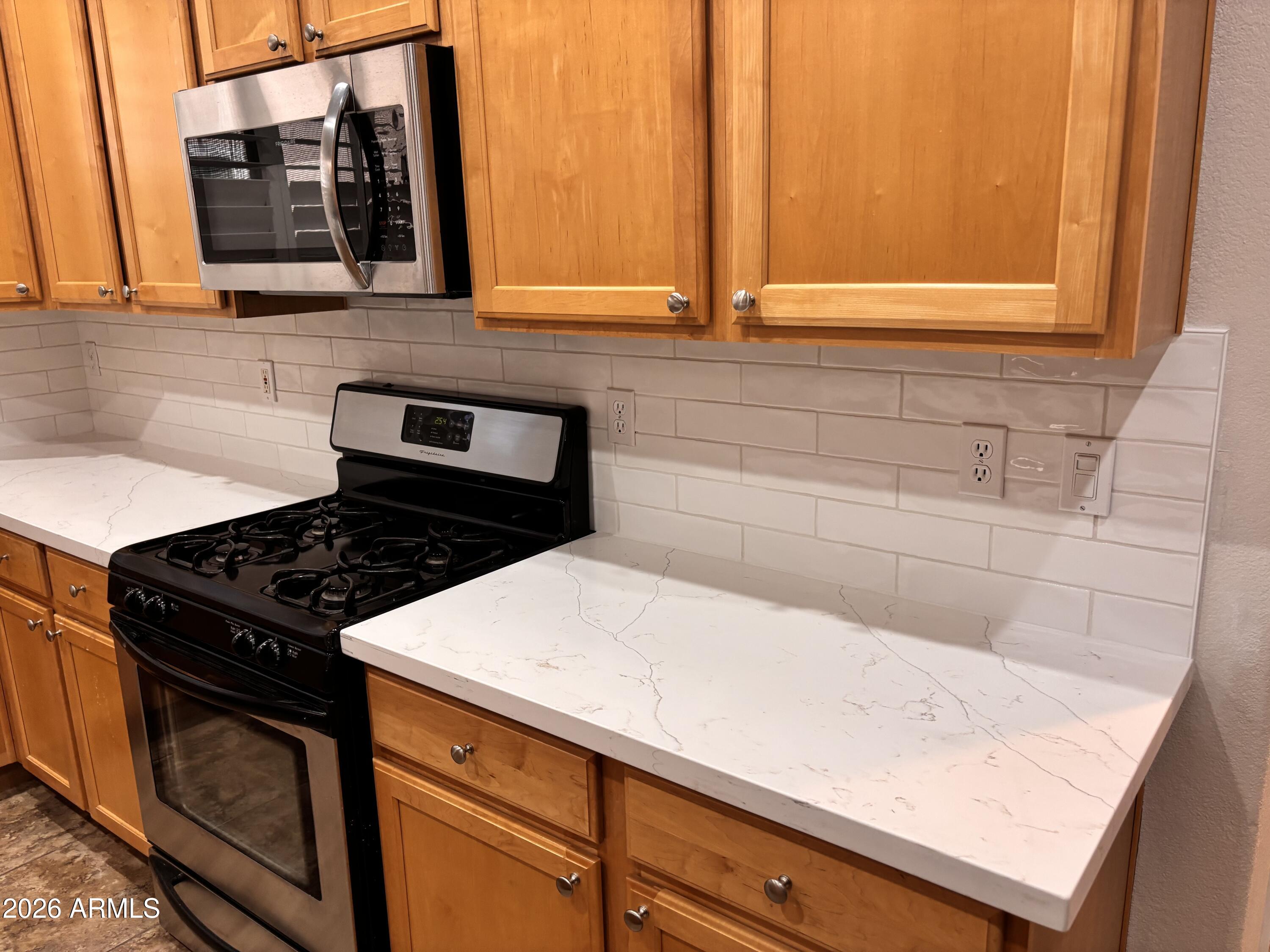 434 East Sheffield Avenue Gilbert, AZ 85296 - Photo 9 of 52 a kitchen with a stove and a sink