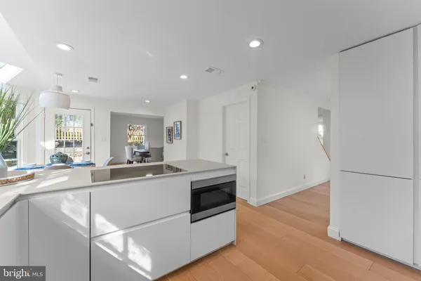 a kitchen with stainless steel appliances a sink stove and cabinets