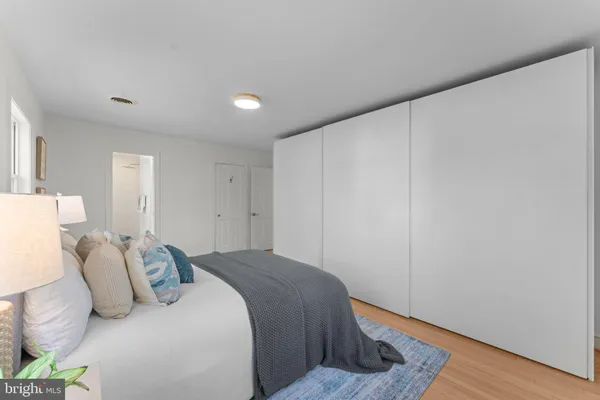 a bedroom with a bed and wooden floor