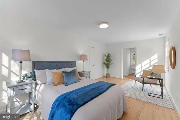 a bedroom with a bed and a lamp on table