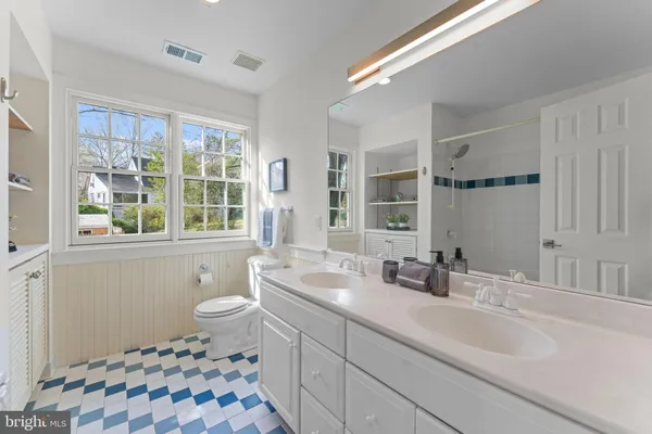 a bathroom with a sink toilet a mirror and shower