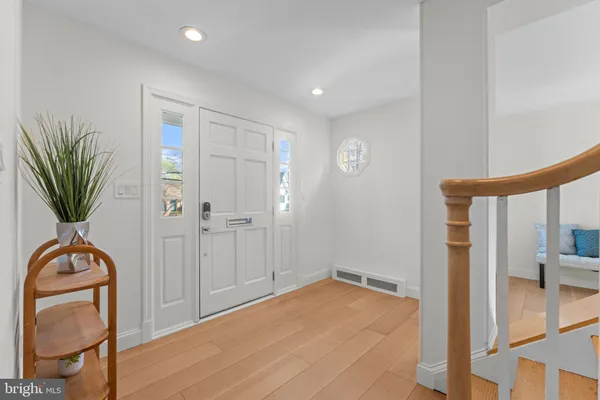 a view of an entryway with wooden floor