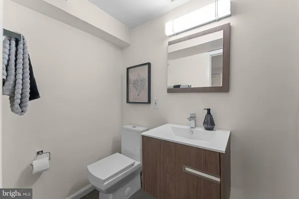 a bathroom with a toilet a sink and mirror