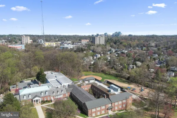 an aerial view of house with yard swimming pool and outdoor seating