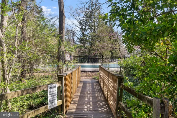 a view of balcony with wooden floor and fence