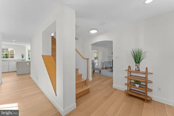 a view of a hallway with furniture and wooden floor
