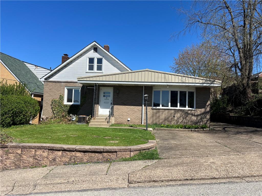 1512 Ridge Avenue New Kensington, PA 15068 - Photo 1 of 20 a front view of a house with a yard