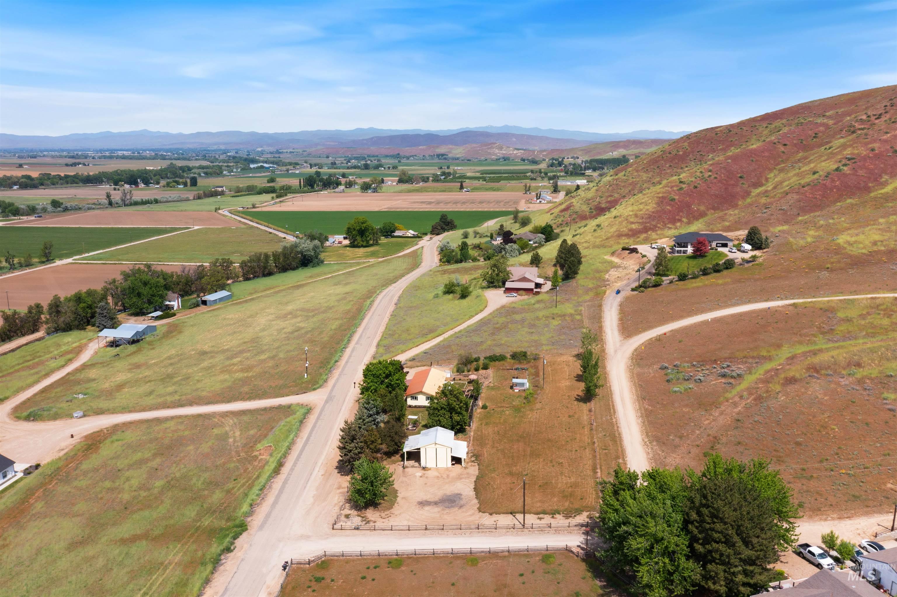 12184 Hill Road Payette, ID 83661 - Photo 6 of 35 Expansive land parcel featuring open fields, scattered trees, and a distant mountain range