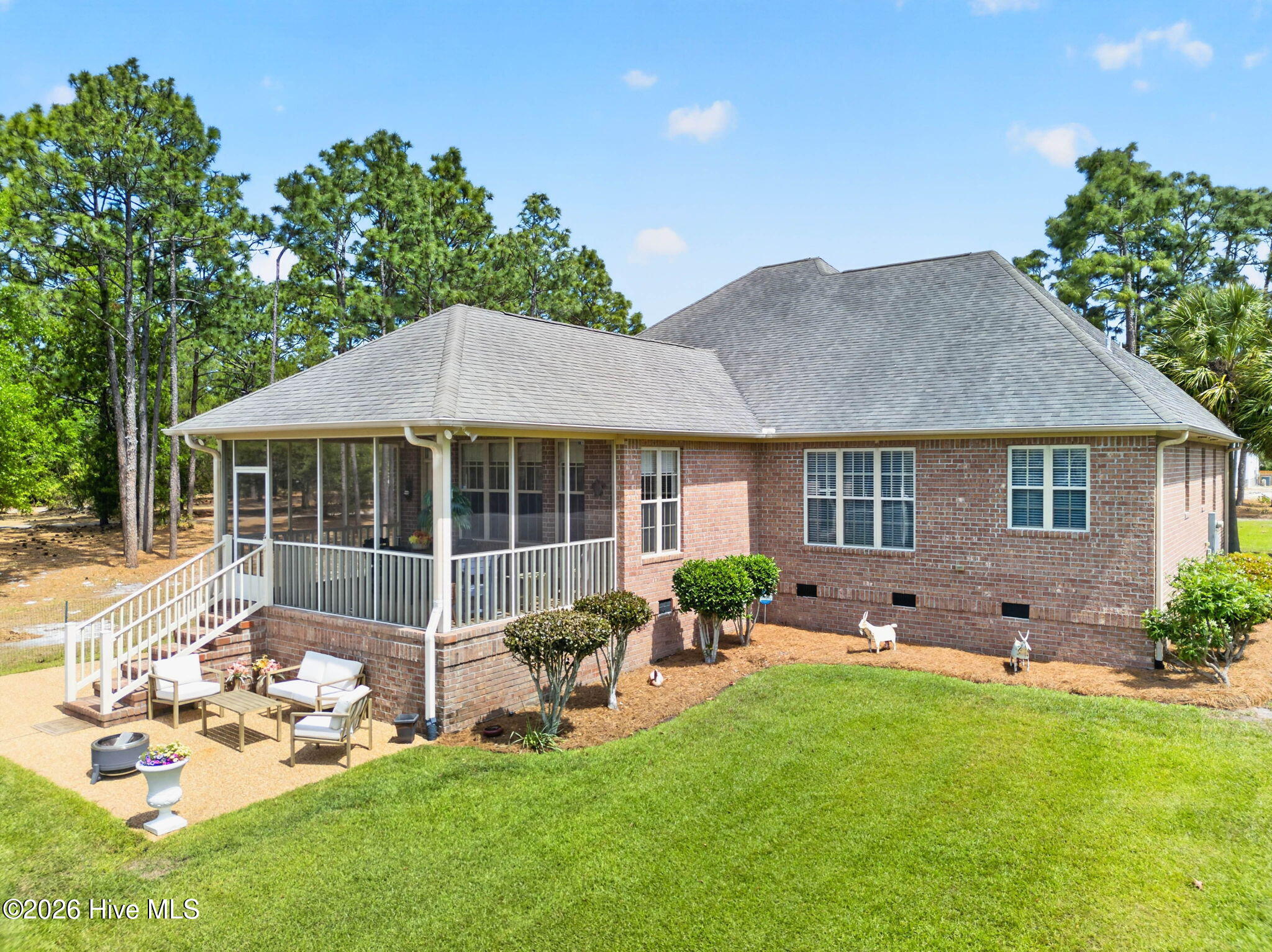 137 Ash Road Southport, NC 28461 - Photo 6 of 64 screened porch, large patio, brick walkway to pool, beautifully landscaped yard with irrigation.