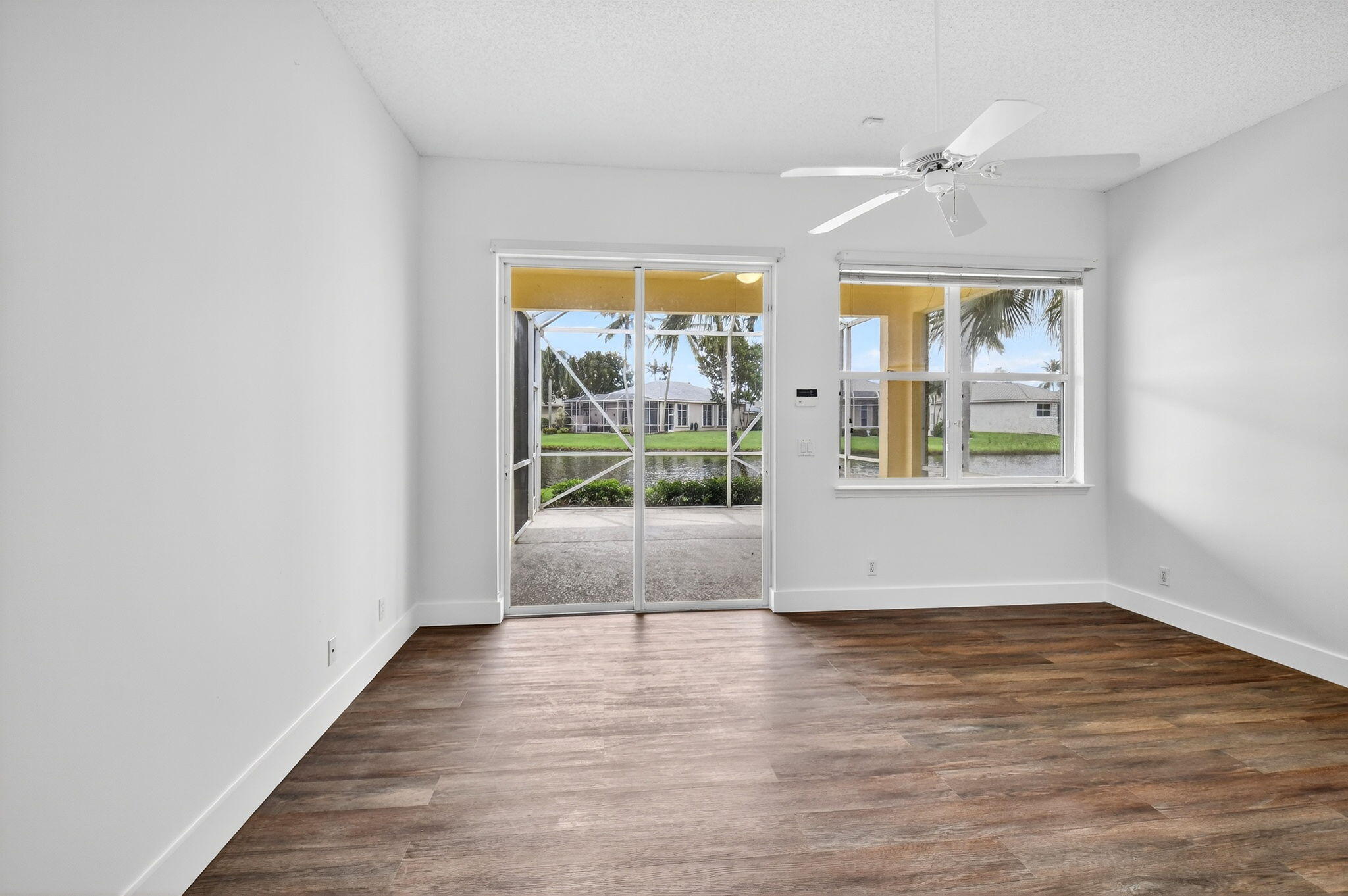 7975 Rockford Road Boynton Beach, FL 33472 - Photo 34 of 79 an empty room with wooden floor and windows