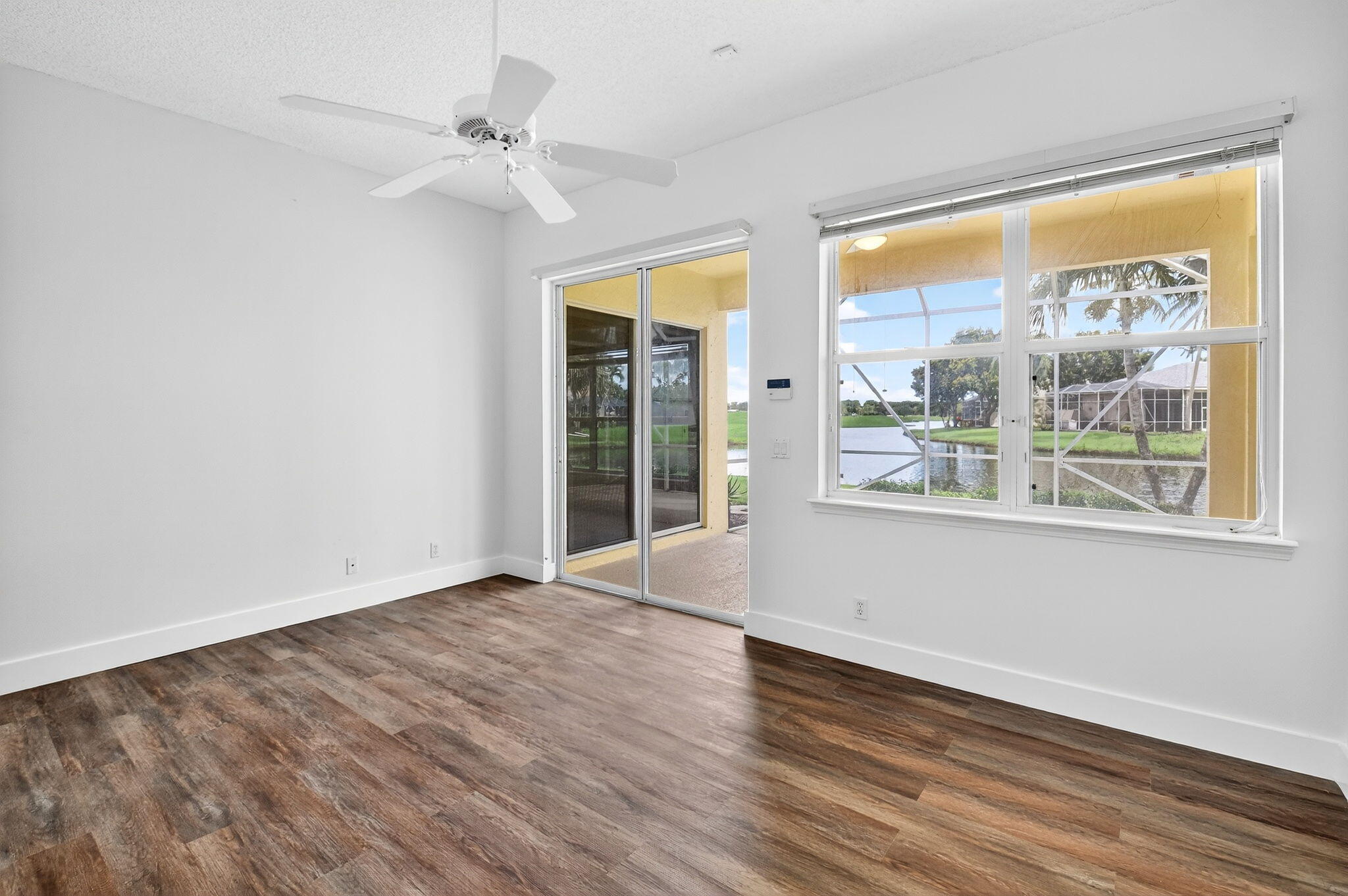 7975 Rockford Road Boynton Beach, FL 33472 - Photo 35 of 79 a view of an empty room with a window and wooden floor