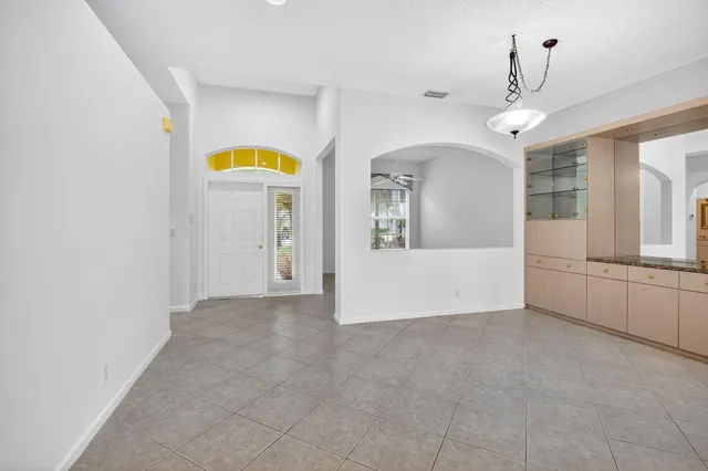 a kitchen with kitchen island stainless steel appliances a stove a sink a center island cabinets and a window