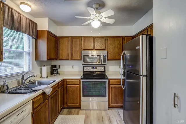 a kitchen with stainless steel appliances granite countertop a refrigerator stove and sink