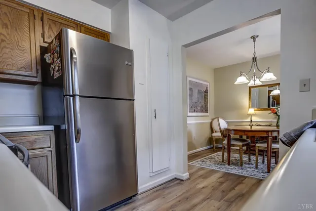a kitchen with stainless steel appliances a refrigerator and a dining table