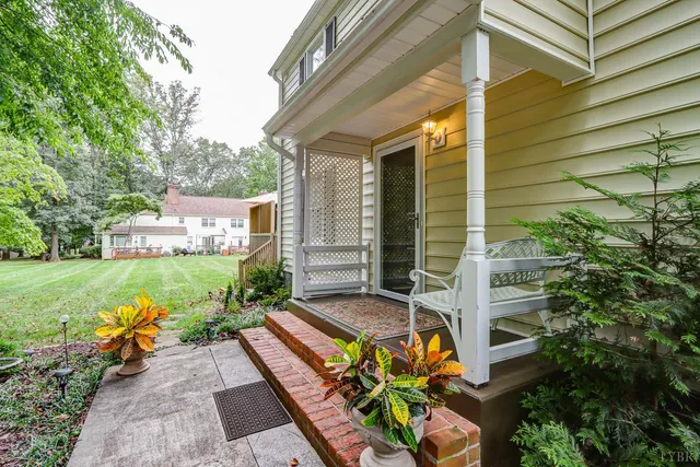 a view of a house with backyard sitting area and garden