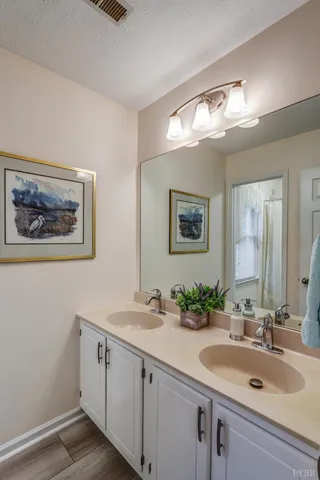 a bathroom with a double vanity sink and a mirror