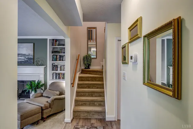 a view of a livingroom with furniture and staircase