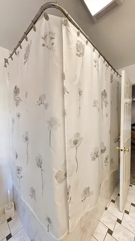 a bathroom with a shower and a mirror