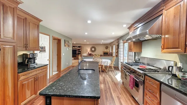 a kitchen with stainless steel appliances granite countertop a stove oven and a refrigerator