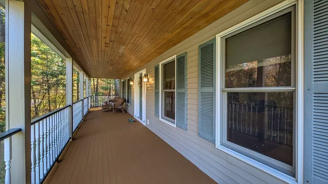 a view of a porch with wooden floor and stairs