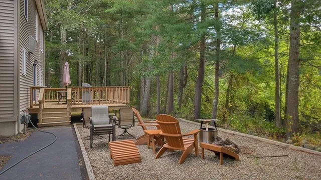 a view of a patio with a table chairs and a backyard