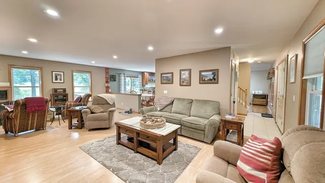 a living room with furniture potted plant and a window