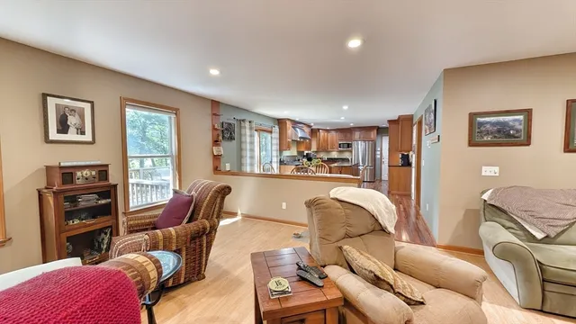 a living room with furniture a ceiling fan and a window