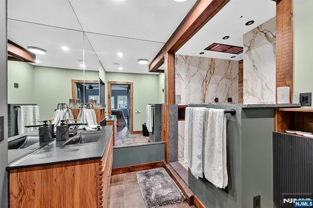 a kitchen with stainless steel appliances kitchen island a stove and a sink