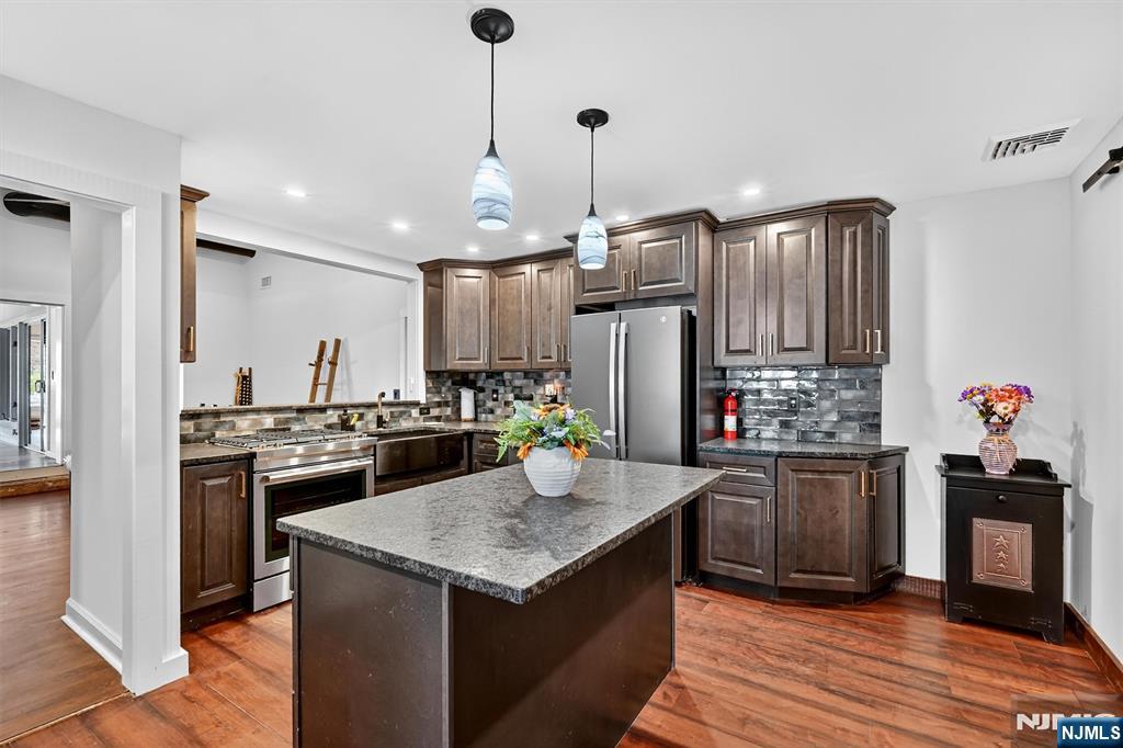 13 Main Street Paterson, NJ 07503 - Photo 25 of 46 a kitchen with granite countertop stainless steel appliances and wooden floor