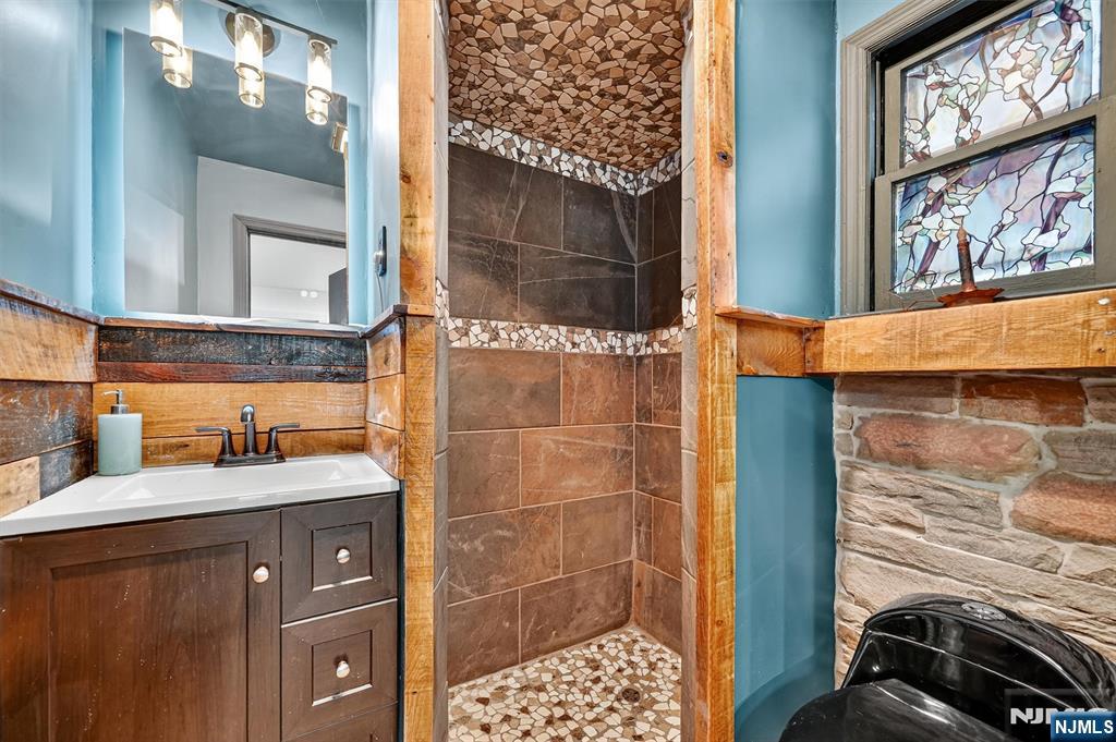 13 Main Street Paterson, NJ 07503 - Photo 27 of 46 a bathroom with a sink and a mirror