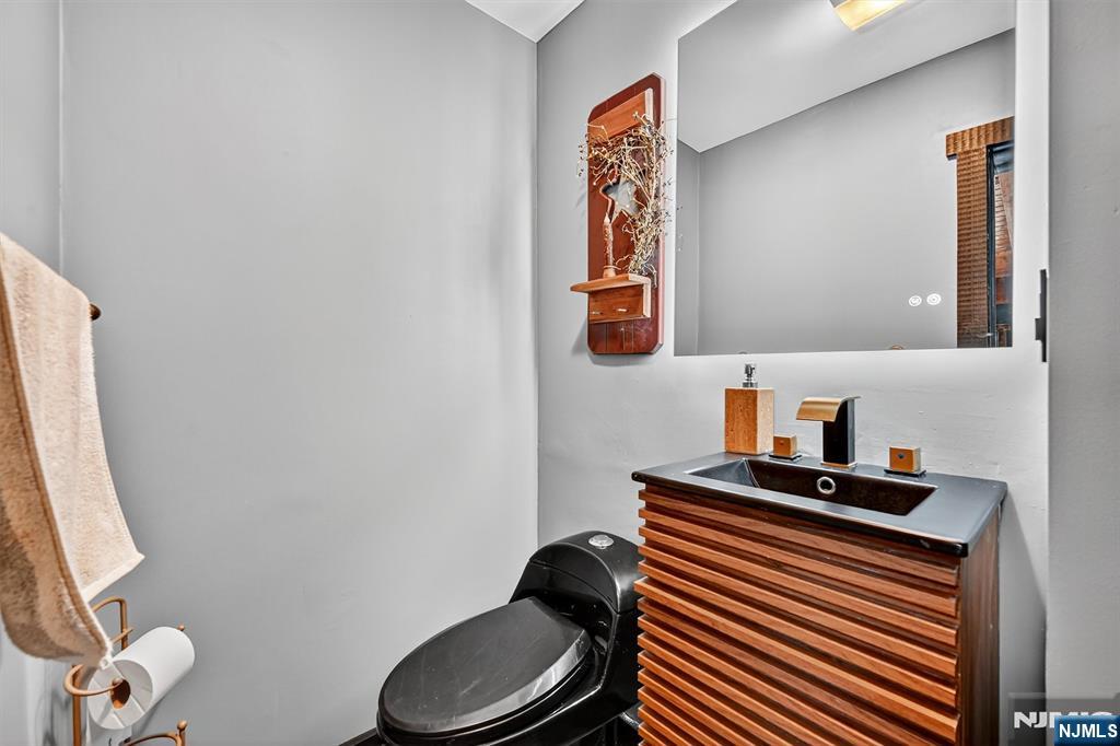 13 Main Street Paterson, NJ 07503 - Photo 30 of 46 a bathroom with a toilet and a sink