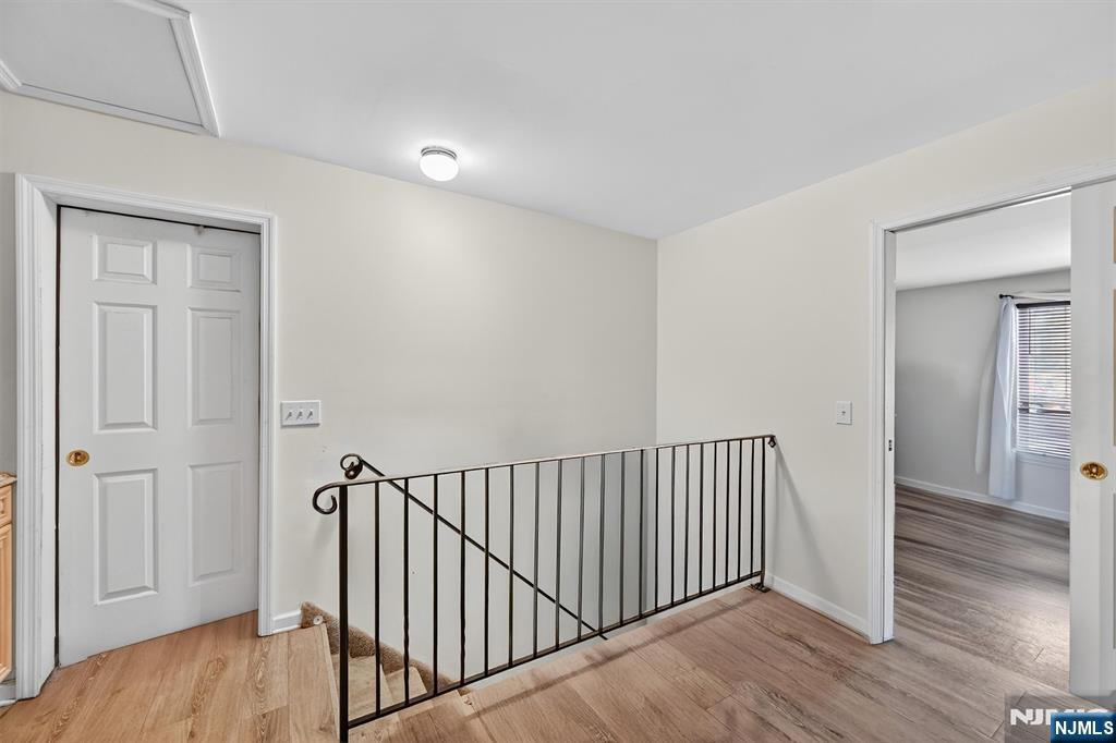 13 Main Street Paterson, NJ 07503 - Photo 5 of 46 a view of a hallway with wooden floor and a bathroom