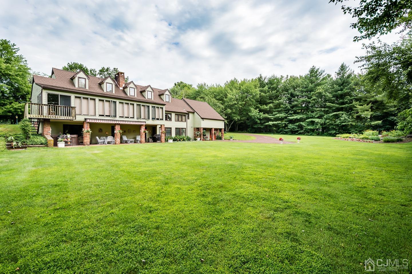 62 Linvale Road Ringoes, NJ 08551 - Photo 2 of 19 a view of a house with a big yard and large trees