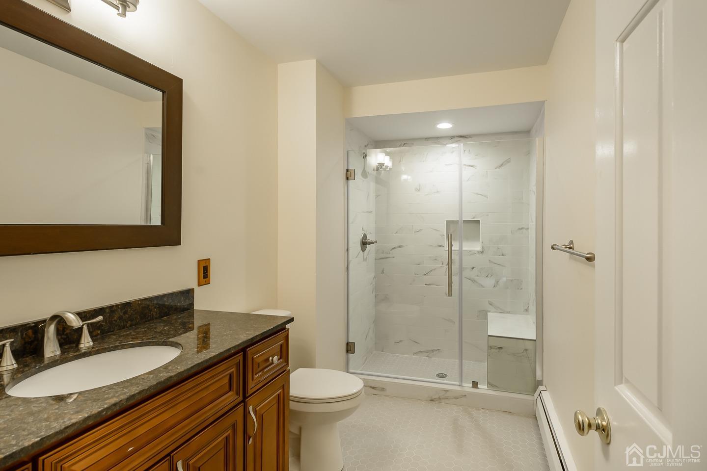 62 Linvale Road Ringoes, NJ 08551 - Photo 12 of 19 a bathroom with a granite countertop sink toilet mirror and shower