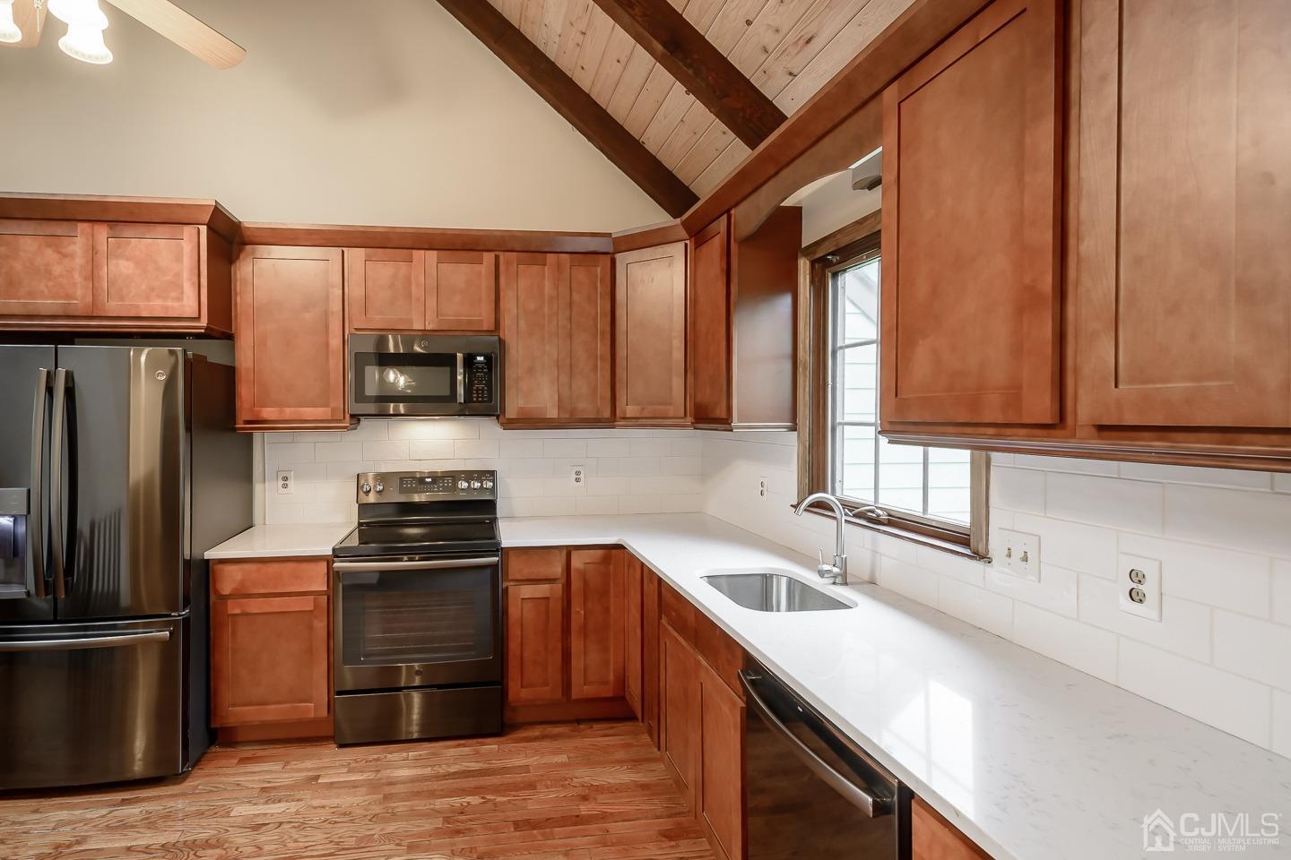 62 Linvale Road Ringoes, NJ 08551 - Photo 4 of 19 a kitchen with stainless steel appliances granite countertop a sink a stove a refrigerator cabinets and a window