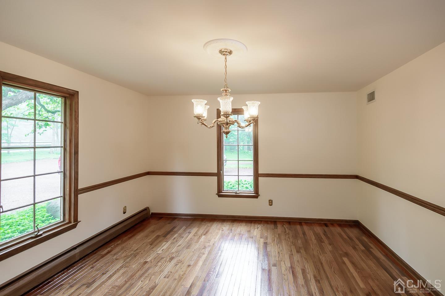 62 Linvale Road Ringoes, NJ 08551 - Photo 9 of 19 a view of a room with wooden floor chandelier and windows