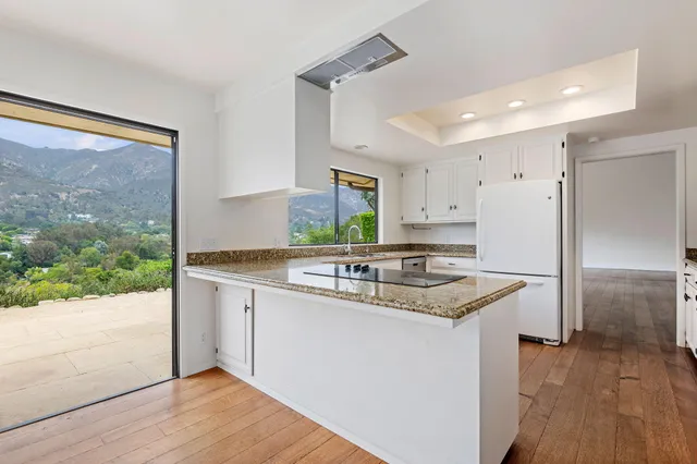 a kitchen with a sink stove and refrigerator