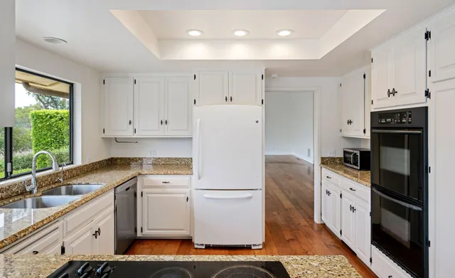 a kitchen with a refrigerator stove and sink