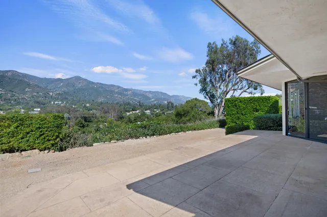 a view of a garden with a building in the background